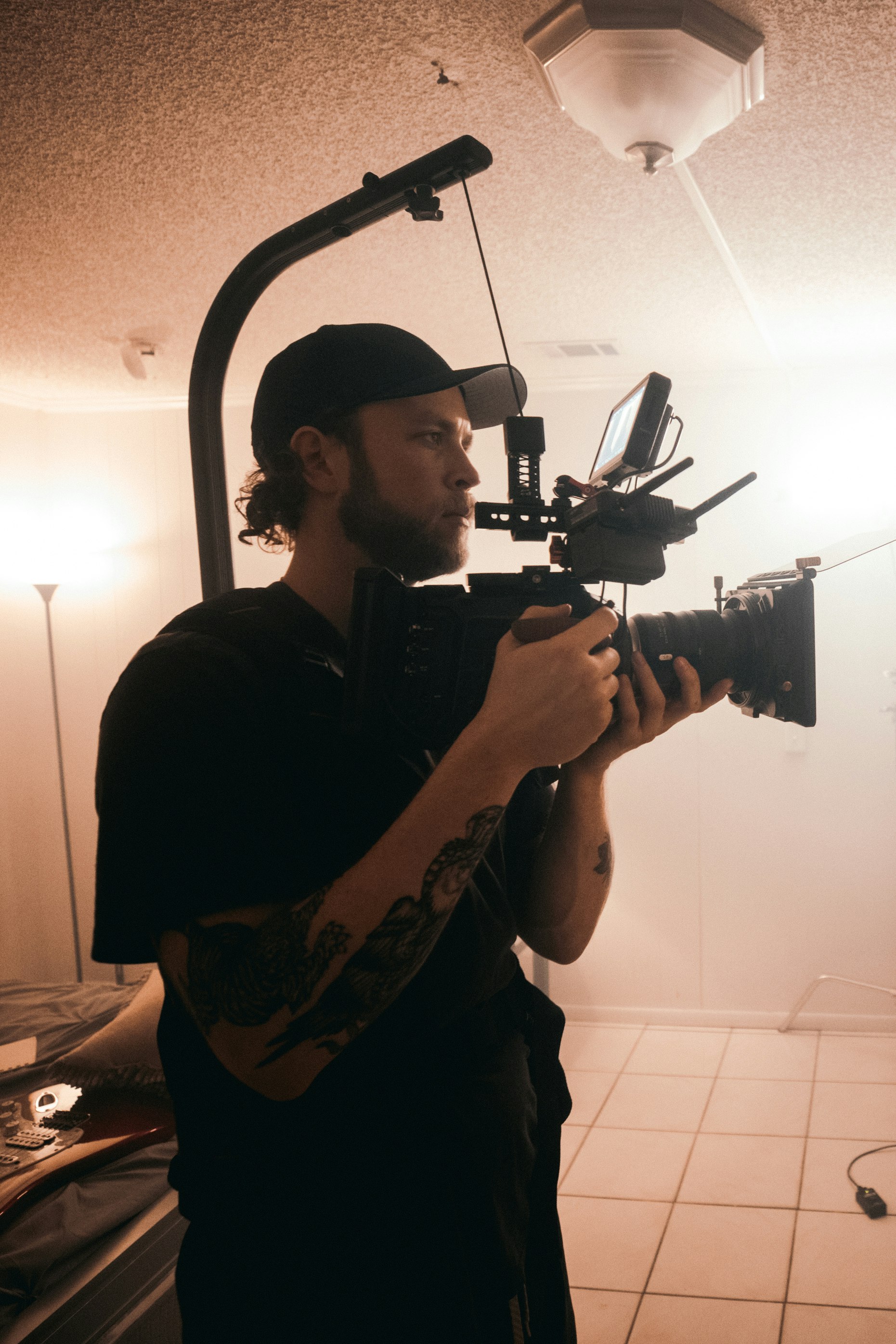 man in black t-shirt holding black video camera